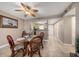 Dining area with glass-top table, wicker chairs, and view of the kitchen at 1230 Gulf Blvd # 402, Clearwater Beach, FL 33767
