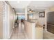 Hallway leading to the kitchen and living room, with shuttered closet doors at 1230 Gulf Blvd # 402, Clearwater Beach, FL 33767