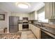 Modern kitchen with stainless steel appliances, granite counters, and ample cabinetry at 1230 Gulf Blvd # 402, Clearwater Beach, FL 33767