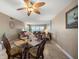 Open living room with dining area, ocean views through large windows, and a ceiling fan at 1230 Gulf Blvd # 402, Clearwater Beach, FL 33767