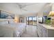 Main bedroom with king-size bed, ceiling fan, ocean view, and balcony access at 1230 Gulf Blvd # 402, Clearwater Beach, FL 33767