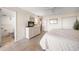 Main bedroom with ceiling fan, dresser, and view of the ensuite bathroom at 1230 Gulf Blvd # 402, Clearwater Beach, FL 33767
