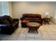 Living room with brown leather furniture and coffee table at 1713 Grand Central Dr, Tarpon Springs, FL 34689