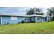 Ranch style home with a light blue exterior and a spacious lawn at 1714 58Th S St, Gulfport, FL 33707