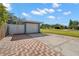 Detached garage with white door and brick paved driveway at 1714 58Th S St, Gulfport, FL 33707