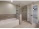 Spacious bathroom featuring walk-in shower, soaking tub, and wood-look tile at 1723 W Palmetto St, Tampa, FL 33607