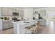 Spacious kitchen featuring an island with seating, stainless steel appliances, and gray cabinetry at 17451 Whiskey Creek Trl, Parrish, FL 34219