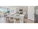 Modern kitchen with gray cabinets, stainless steel appliances, and a large island at 17451 Whiskey Creek Trl, Parrish, FL 34219