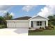 Charming single-story home with a three-car garage and landscaped yard at 17459 Whiskey Creek Trl, Parrish, FL 34219