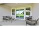 Covered patio with outdoor furniture overlooking green space at 17463 Whiskey Creek Trl, Parrish, FL 34219