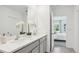 Bright bathroom featuring dual vanities, white countertop, and gray cabinetry at 17463 Whiskey Creek Trl, Parrish, FL 34219