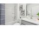 Bathroom with a shower/tub combo, white vanity, and decorative accents at 17463 Whiskey Creek Trl, Parrish, FL 34219