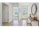 Bright and airy entryway with tile flooring, a console table, and a view into the living area at 17463 Whiskey Creek Trl, Parrish, FL 34219