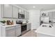 Modern kitchen featuring gray shaker cabinets, stainless steel appliances, and white countertops at 17463 Whiskey Creek Trl, Parrish, FL 34219