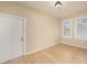 Spacious bedroom with wood floors and two windows at 1910 E Columbus Dr, Tampa, FL 33605