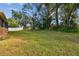 Expansive backyard with a large lawn and private wooded area at 2212 Valterra Vista Way, Valrico, FL 33594