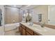Bathroom with tub, shower, and double vanity at 2212 Valterra Vista Way, Valrico, FL 33594