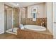 Bathroom with a large soaking tub and walk-in shower at 2212 Valterra Vista Way, Valrico, FL 33594