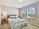 Bright bedroom with window, neutral decor, and ample natural light at 2212 Valterra Vista Way, Valrico, FL 33594