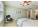 Comfortable bedroom with a chair and large window at 2212 Valterra Vista Way, Valrico, FL 33594