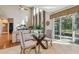 Breakfast nook with a glass table and chairs, near sliding doors to backyard at 2212 Valterra Vista Way, Valrico, FL 33594