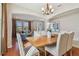Sunlit dining room with hardwood floors and a view into the living room at 2212 Valterra Vista Way, Valrico, FL 33594