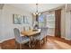 Elegant dining room with hardwood floors, a wood table, and neutral decor at 2212 Valterra Vista Way, Valrico, FL 33594