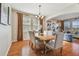 Spacious dining room with hardwood floors, a large table, and access to living room at 2212 Valterra Vista Way, Valrico, FL 33594