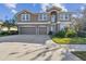 Two-story house with three-car garage and manicured lawn at 2212 Valterra Vista Way, Valrico, FL 33594