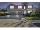 Two-story house with three-car garage and landscaped yard at 2212 Valterra Vista Way, Valrico, FL 33594
