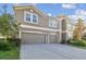 Two-story house with three-car garage and neatly landscaped yard at 2212 Valterra Vista Way, Valrico, FL 33594