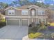 Two-story house with a three-car garage and landscaped yard at 2212 Valterra Vista Way, Valrico, FL 33594