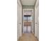View down a hallway showcasing access to a bright room with tile floors and large windows at 2212 Valterra Vista Way, Valrico, FL 33594