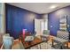 Spacious home office with navy walls, wood floors, and a built-in workspace at 2212 Valterra Vista Way, Valrico, FL 33594