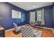Home office with navy walls, wood floors, and a workspace with two chairs at 2212 Valterra Vista Way, Valrico, FL 33594