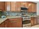 Stainless steel range and microwave in kitchen with granite countertops at 2212 Valterra Vista Way, Valrico, FL 33594