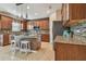Kitchen features island with seating, stainless steel appliances, and granite countertops at 2212 Valterra Vista Way, Valrico, FL 33594