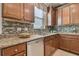 Double sink and granite countertop in kitchen with wood cabinets at 2212 Valterra Vista Way, Valrico, FL 33594