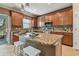 Granite island kitchen with seating and stainless steel appliances at 2212 Valterra Vista Way, Valrico, FL 33594