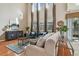 Bright living room with high ceilings, hardwood floors, and a cozy seating area at 2212 Valterra Vista Way, Valrico, FL 33594