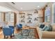 Bright living room with hardwood floors, comfy seating, and built-in shelves at 2212 Valterra Vista Way, Valrico, FL 33594