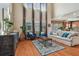 Open living room with hardwood floors, large windows, and a view into the kitchen at 2212 Valterra Vista Way, Valrico, FL 33594