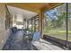 Relaxing screened porch with slate tile flooring and outdoor seating at 2212 Valterra Vista Way, Valrico, FL 33594