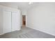 Neutral bedroom with grey carpet, ceiling fan, and adjacent bathroom access at 22707 Eagles Watch Dr, Land O Lakes, FL 34639