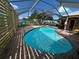 Inviting kidney-shaped pool with a screened enclosure at 2765 Mauritania Rd, Punta Gorda, FL 33983