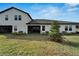 Home's backyard with covered patio and ample green space at 31451 Moniker Mast Ln, San Antonio, FL 33576