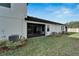 Home's backyard with screened patio and central AC units at 31451 Moniker Mast Ln, San Antonio, FL 33576