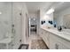Elegant bathroom with double vanity, large shower, and updated fixtures at 31451 Moniker Mast Ln, San Antonio, FL 33576