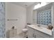 Bright bathroom featuring white vanity, shower, and blue patterned shower curtain at 31451 Moniker Mast Ln, San Antonio, FL 33576