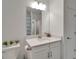Modern bathroom with white vanity, quartz countertop and a large mirror at 31451 Moniker Mast Ln, San Antonio, FL 33576
